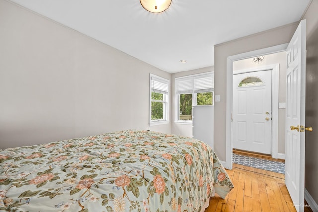 bedroom with baseboards, light wood-style floors, and recessed lighting
