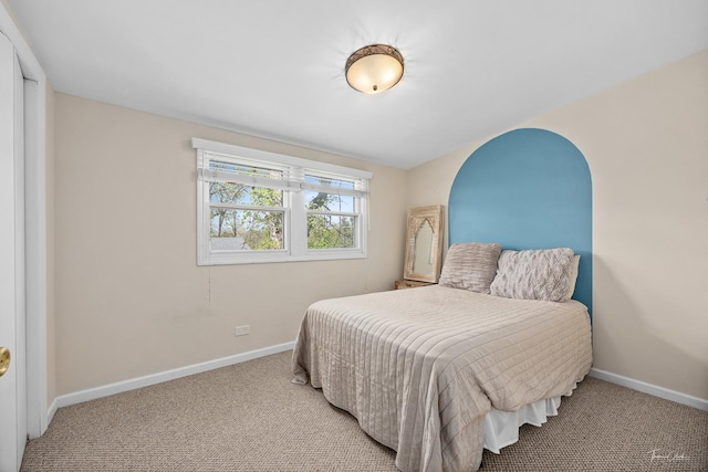 bedroom featuring carpet and baseboards