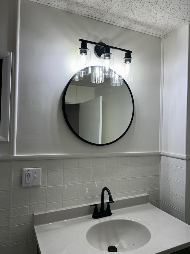bathroom with tile walls, vanity, and tasteful backsplash