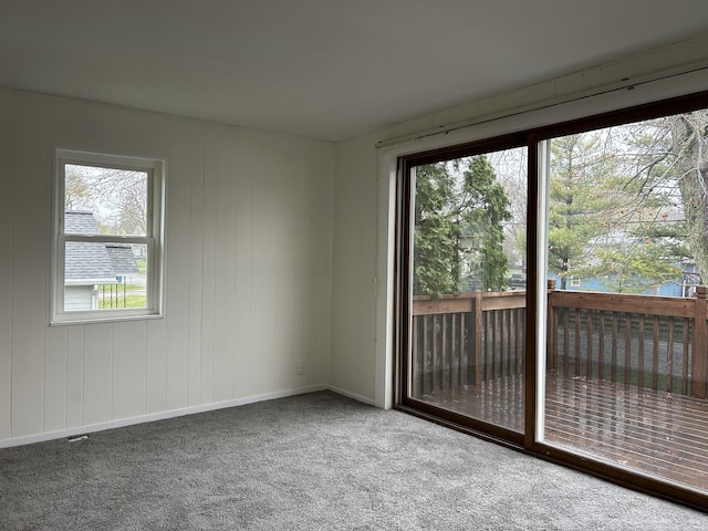 spare room with baseboards and carpet