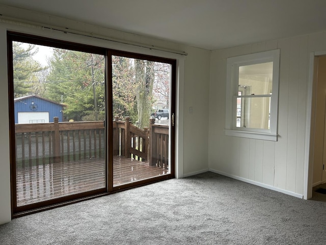 entryway featuring baseboards and carpet flooring