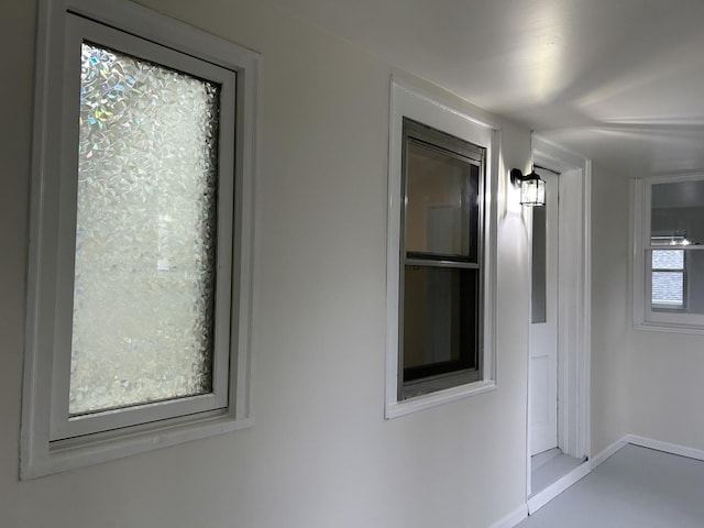 hall featuring baseboards
