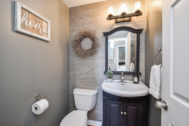 half bath featuring toilet and vanity
