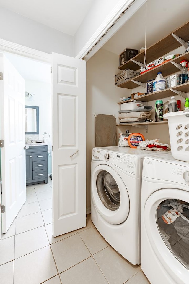 laundry area with independent washer and dryer, laundry area, and light tile patterned flooring