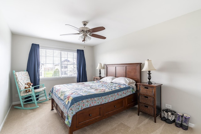 bedroom with light carpet, baseboards, and ceiling fan