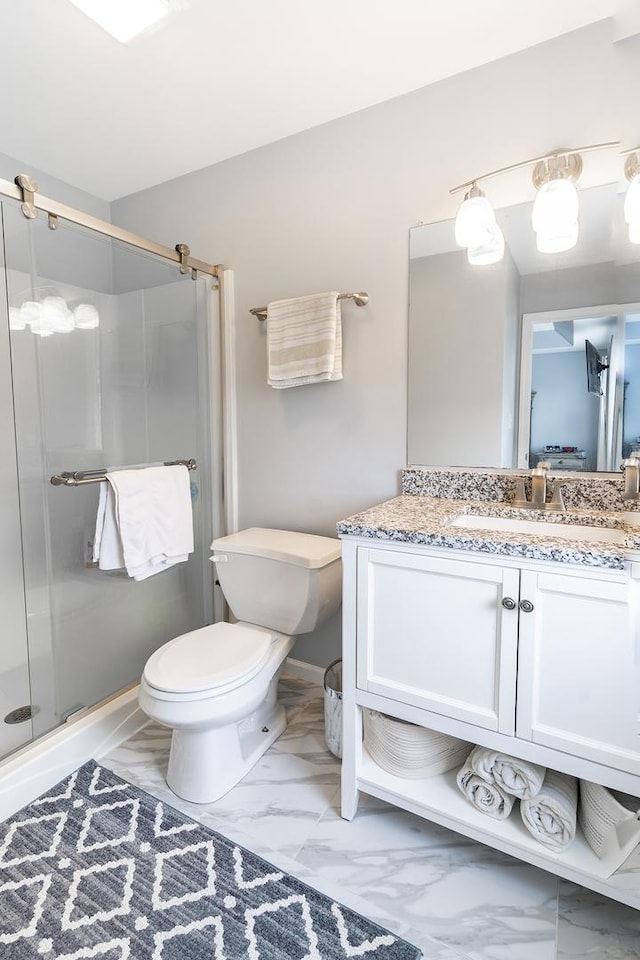 full bathroom with a shower stall, marble finish floor, vanity, and toilet