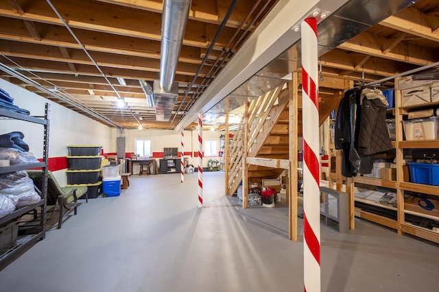 below grade area featuring electric panel and stairs