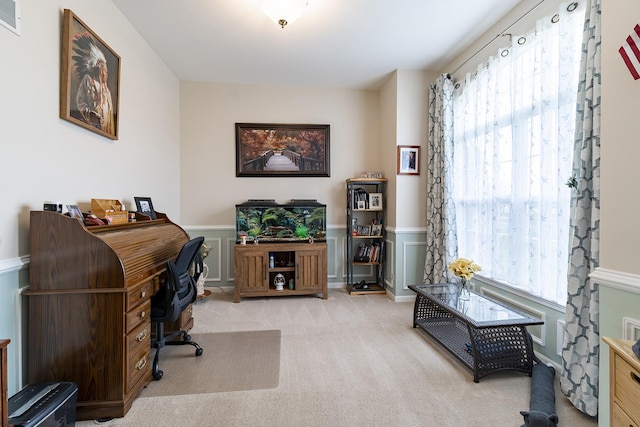 office space featuring wainscoting, visible vents, and carpet