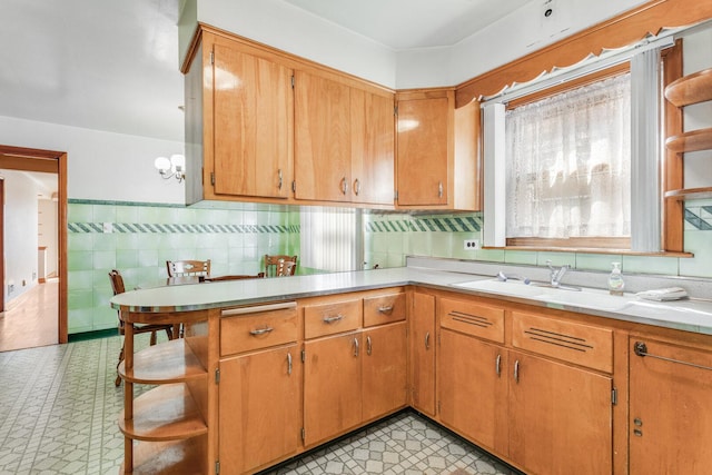 kitchen featuring light floors, open shelves, a sink, and light countertops