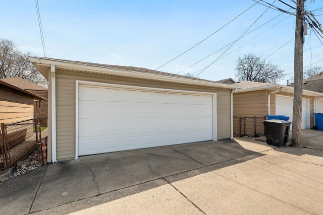 detached garage featuring fence