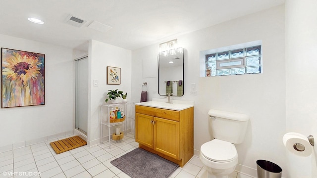 bathroom featuring vanity, toilet, tile patterned floors, and a stall shower