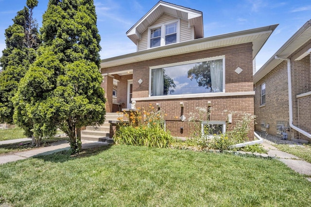 view of front of house featuring a porch, brick siding, and a front yard