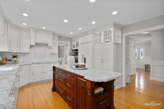 1454 Rill Ct, Naperville, IL 60565 - kitchen with light stone countertops, light wood-type flooring, white cabinets, black electric stovetop, and glass insert cabinets
