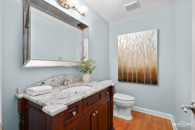 1454 Rill Ct, Naperville, IL 60565 - bathroom featuring visible vents, wood finished floors, vanity, baseboards, and toilet
