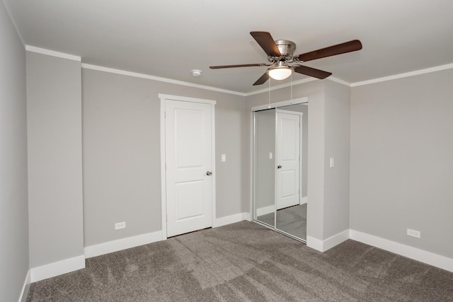 unfurnished bedroom featuring carpet floors, a closet, baseboards, and ornamental molding