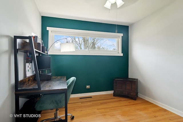office area featuring wood finished floors, visible vents, and baseboards
