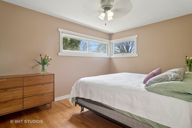 bedroom featuring wood finished floors, ceiling fan, and baseboards