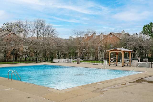 community pool featuring a gazebo, fence, and a patio