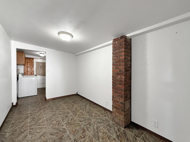 unfurnished room with baseboards
