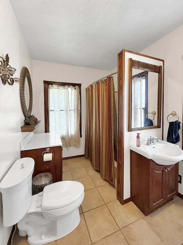 bathroom featuring toilet, a shower with curtain, tile patterned floors, and baseboards