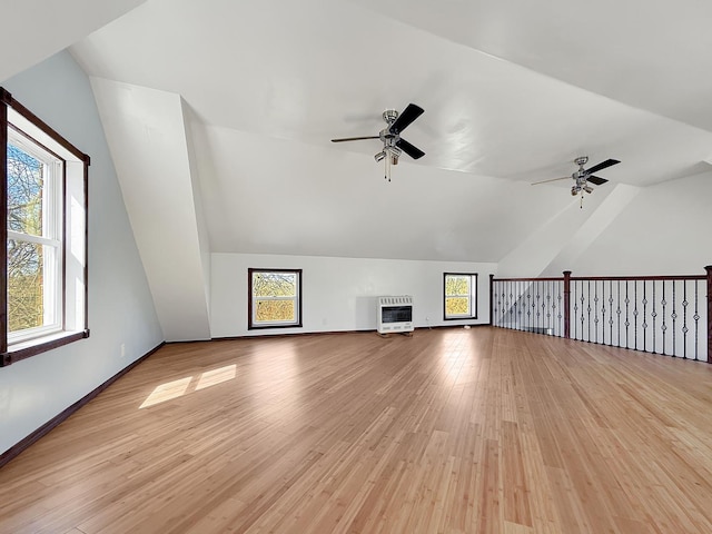 bonus room featuring heating unit, vaulted ceiling, light wood-type flooring, and ceiling fan