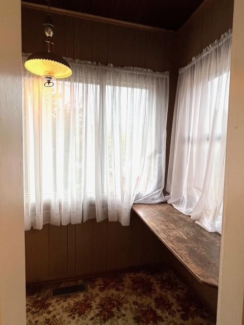unfurnished sunroom featuring visible vents
