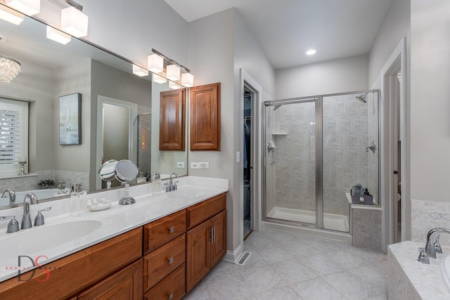 bathroom with a garden tub, a sink, and a stall shower