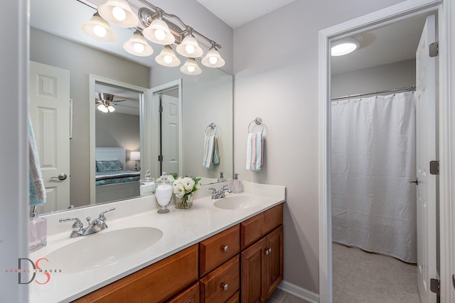 full bathroom featuring ensuite bathroom, a sink, double vanity, and a ceiling fan