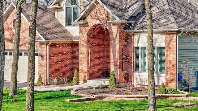 property entrance featuring brick siding, a shingled roof, and a garage