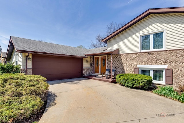 1338 E Best Dr, Arlington Heights, IL 60004 - tri-level home featuring driveway, a shingled roof, brick siding, and a garage