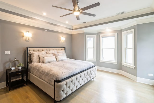 bedroom featuring baseboards, light wood-style floors, and visible vents