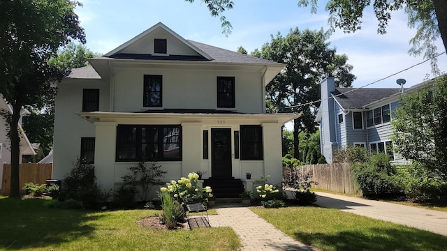traditional style home with stucco siding, entry steps, and a shingled roof