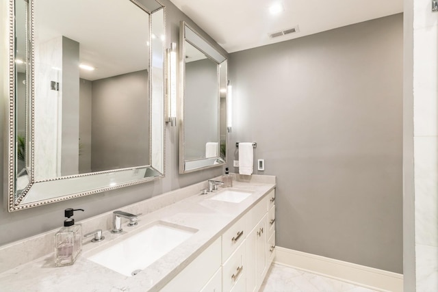 bathroom featuring baseboards, marble finish floor, visible vents, and a sink