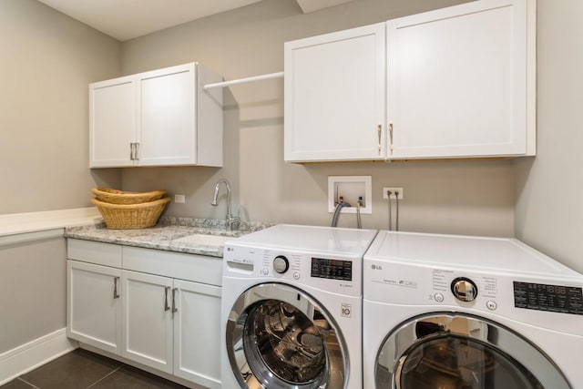 clothes washing area featuring cabinet space, dark tile patterned floors, separate washer and dryer, and a sink