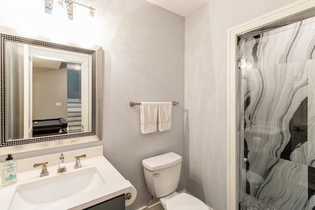 full bath with a shower stall, toilet, and vanity
