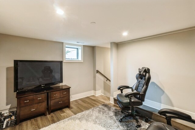 workout area featuring wood finished floors, baseboards, and recessed lighting