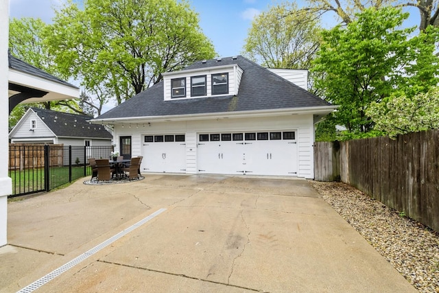 detached garage featuring fence