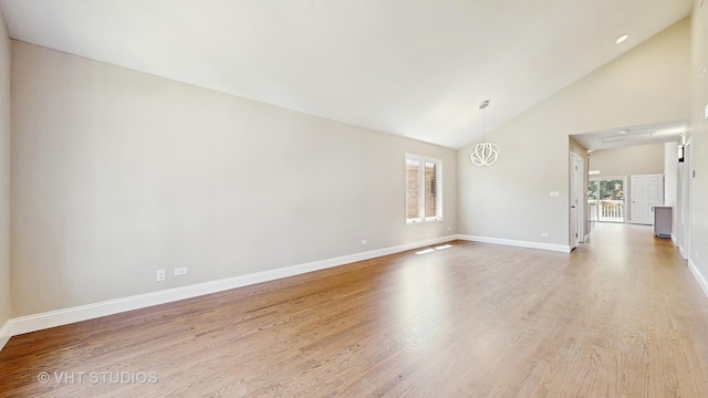 1544 N Wolf Rd, Berkeley, IL 60163 - unfurnished living room with plenty of natural light, wood finished floors, baseboards, and high vaulted ceiling