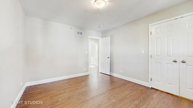 1544 N Wolf Rd, Berkeley, IL 60163 - unfurnished bedroom with wood finished floors, baseboards, and a closet