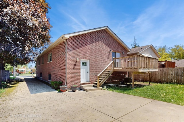 1544 N Wolf Rd, Berkeley, IL 60163 - rear view of house featuring fence, brick siding, and a deck