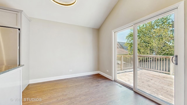 1544 N Wolf Rd, Berkeley, IL 60163 - unfurnished room with light wood-type flooring, lofted ceiling, and baseboards