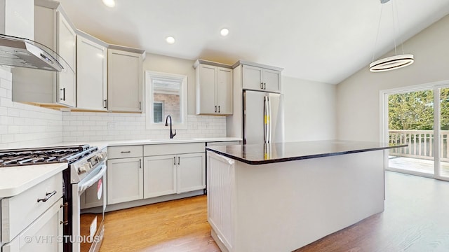 1544 N Wolf Rd, Berkeley, IL 60163 - kitchen with appliances with stainless steel finishes, a sink, wall chimney exhaust hood, light wood-type flooring, and lofted ceiling