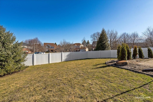 view of yard featuring a residential view and a fenced backyard