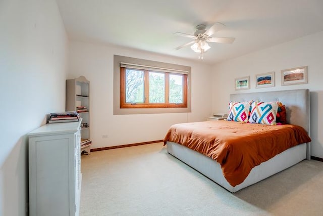 bedroom featuring baseboards, light carpet, and a ceiling fan