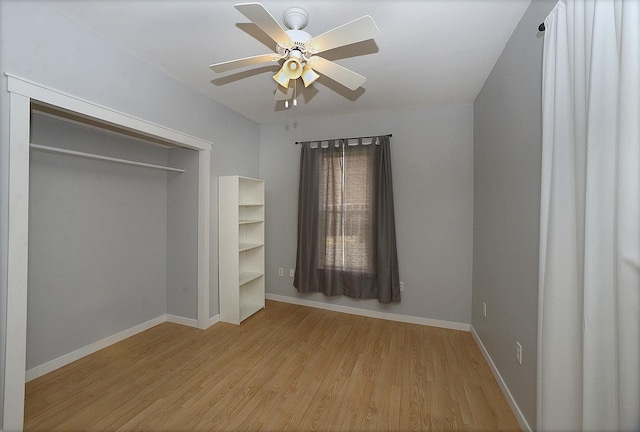 112 W Porter St, Oglesby, IL 61348 - unfurnished bedroom with baseboards, ceiling fan, wood finished floors, and a closet