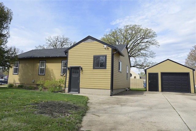 112 W Porter St, Oglesby, IL 61348 - exterior space featuring an outdoor structure, a lawn, a detached garage, and concrete driveway