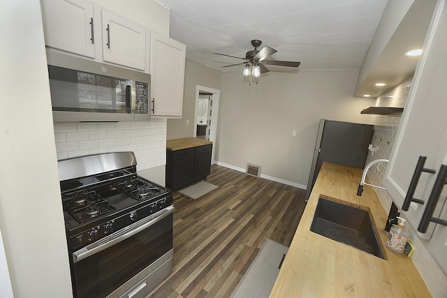 112 W Porter St, Oglesby, IL 61348 - kitchen with decorative backsplash, visible vents, baseboards, wood counters, and stainless steel appliances