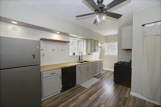 112 W Porter St, Oglesby, IL 61348 - kitchen with open shelves, butcher block countertops, dark wood-style floors, a sink, and black appliances