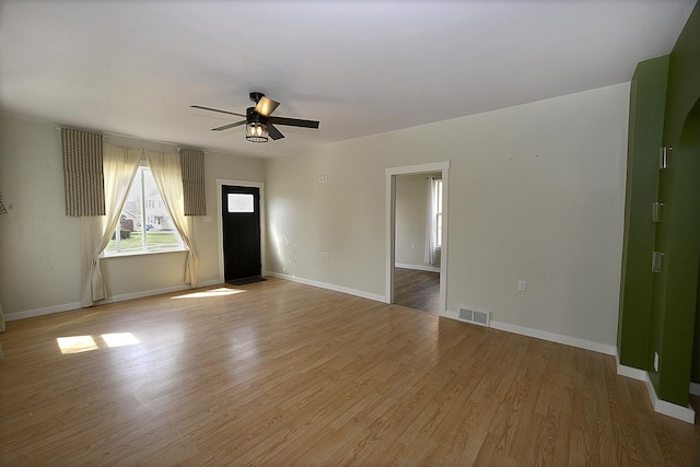 112 W Porter St, Oglesby, IL 61348 - unfurnished living room with baseboards, a ceiling fan, wood finished floors, and visible vents