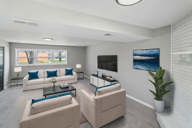 carpeted living area with visible vents and baseboards